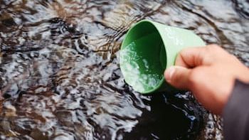 person scooping water